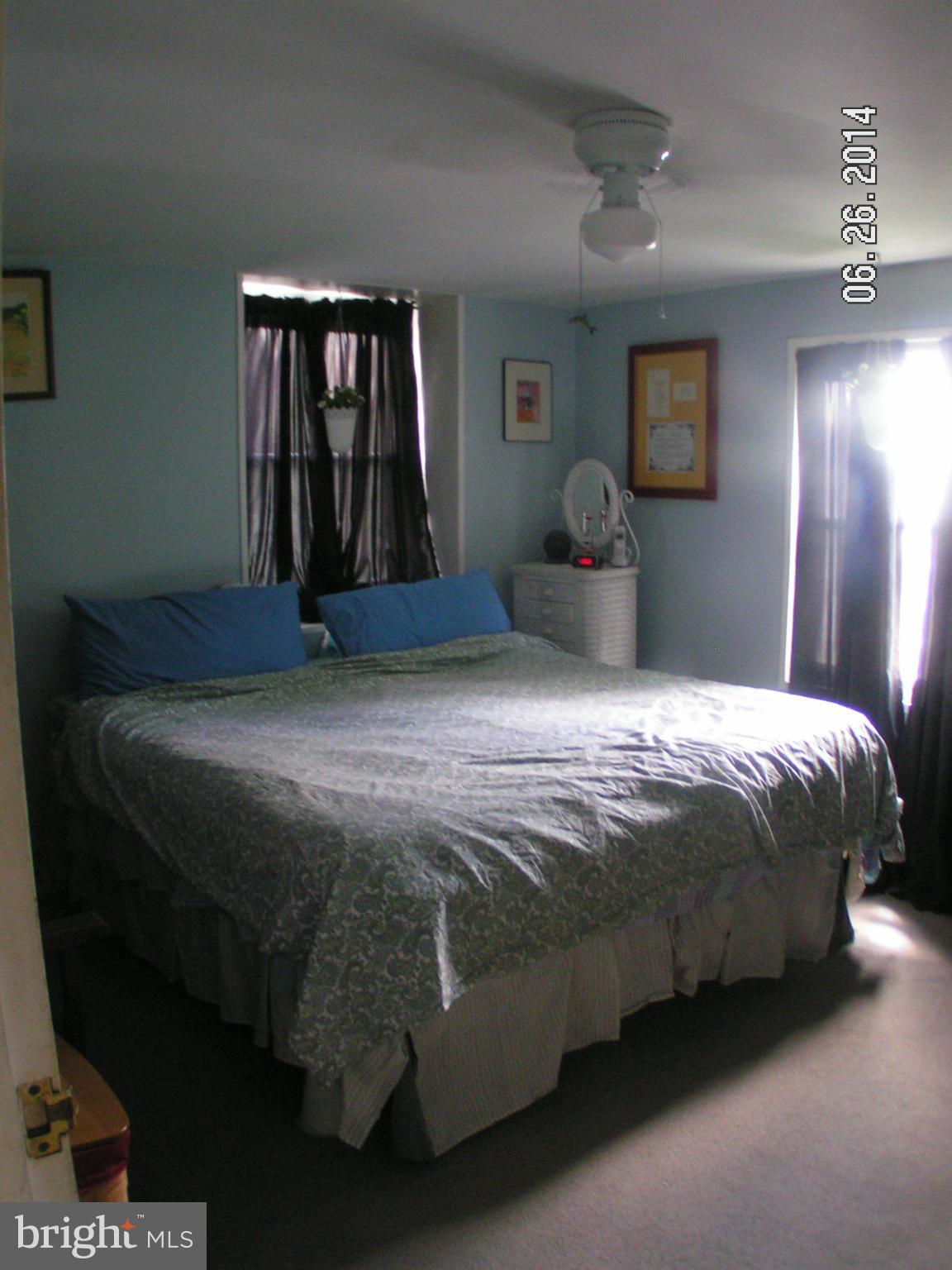 7413 Forrest Avenue Baltimore, MD 21234 - Photo 11 of 14 a bedroom with a bed dresser and mirror