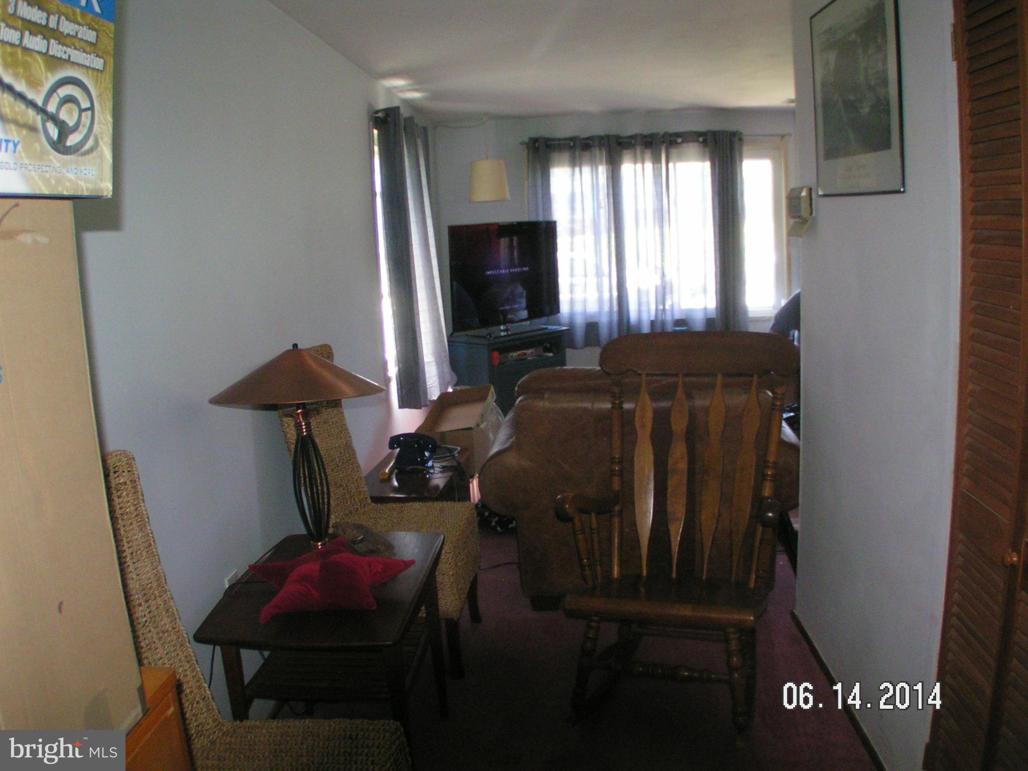 7413 Forrest Avenue Baltimore, MD 21234 - Photo 4 of 14 a living room with furniture a flat screen tv and a window