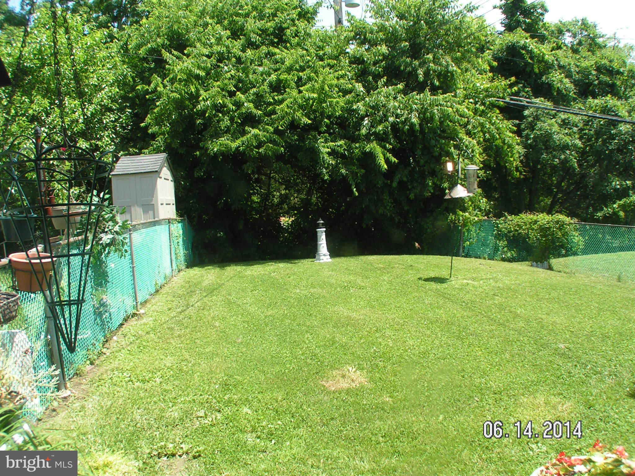 7413 Forrest Avenue Baltimore, MD 21234 - Photo 5 of 14 a backyard of a house with lots of green space