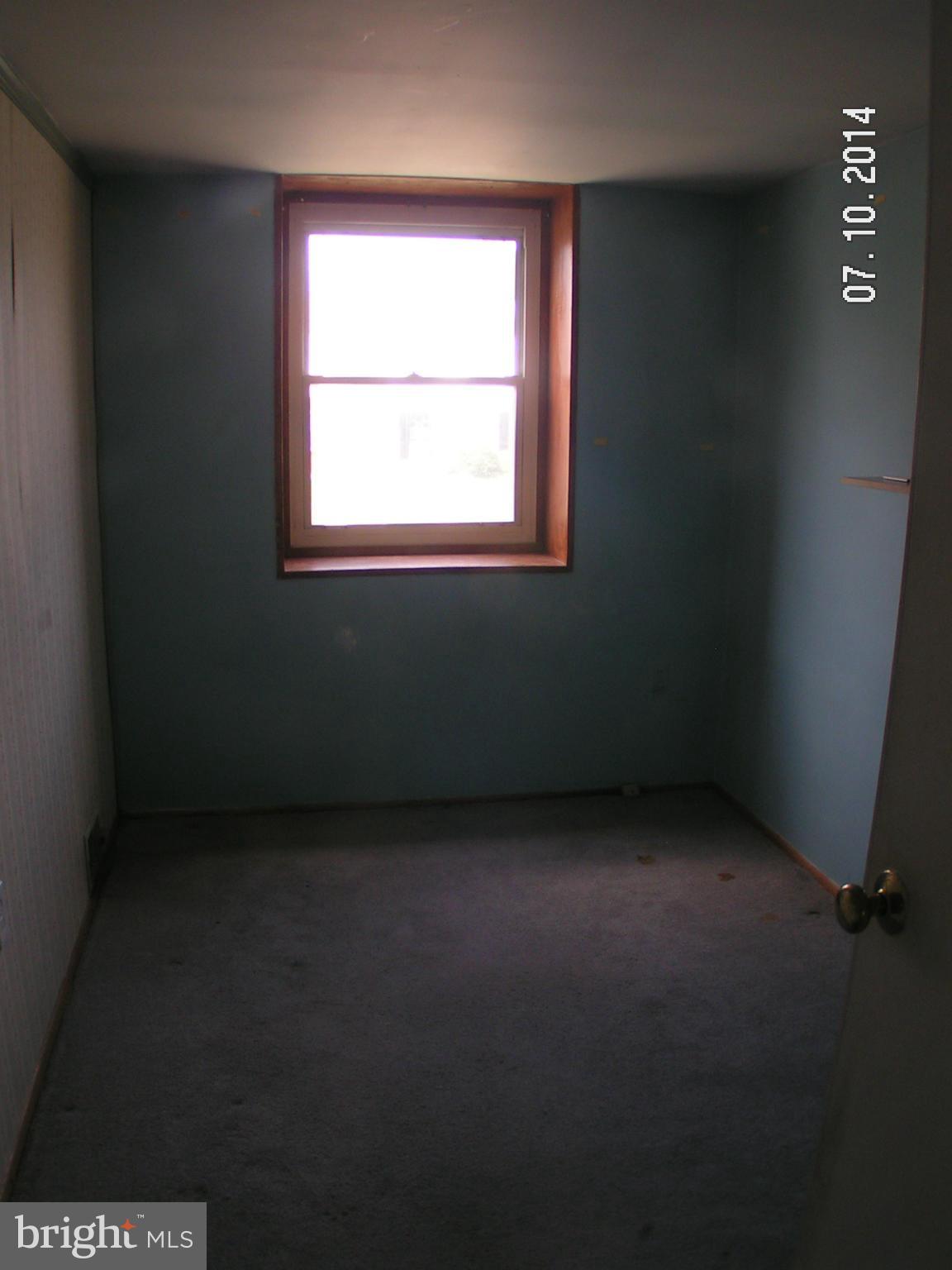 7413 Forrest Avenue Baltimore, MD 21234 - Photo 9 of 14 an empty room with a window