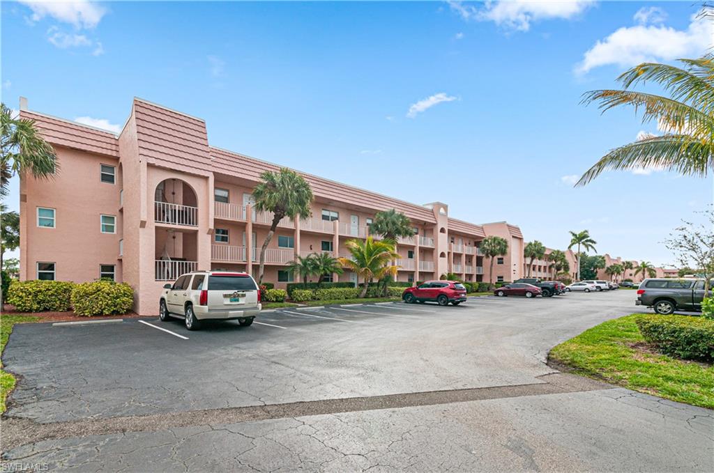 225 Turtle Lake Court, Unit 209 Naples, FL 34105 - Photo 13 of 15 a car parked in front of a building