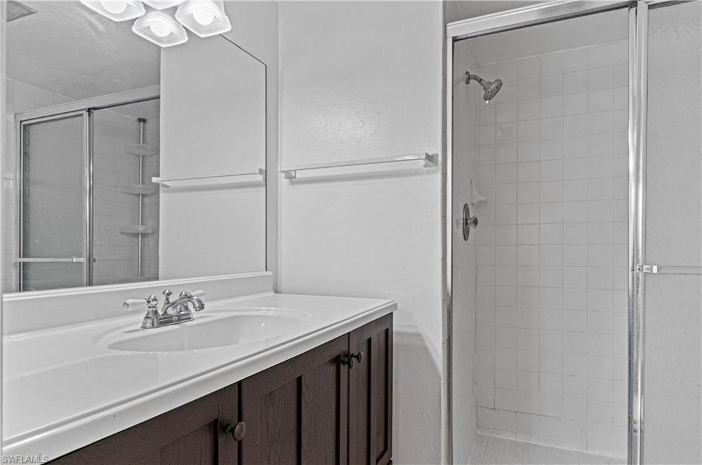 225 Turtle Lake Court, Unit 209 Naples, FL 34105 - Photo 6 of 15 a bathroom with a sink and a mirror