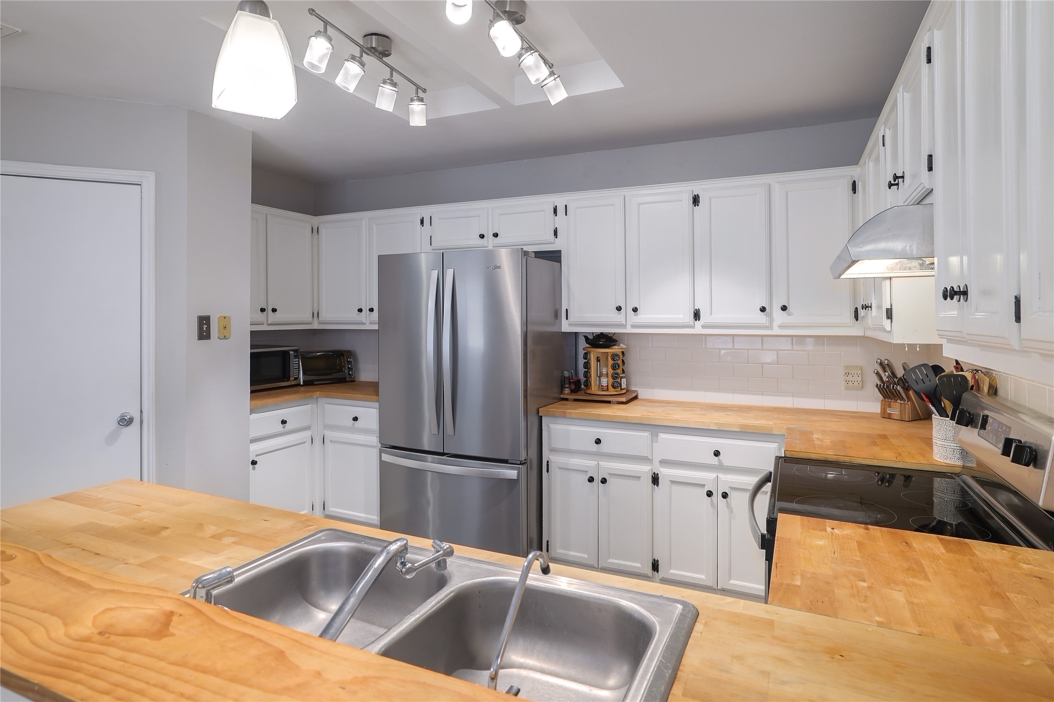 827 Topaz Lane Leander, TX 78641 - Photo 13 of 22 a kitchen with stainless steel appliances granite countertop a refrigerator sink and cabinets