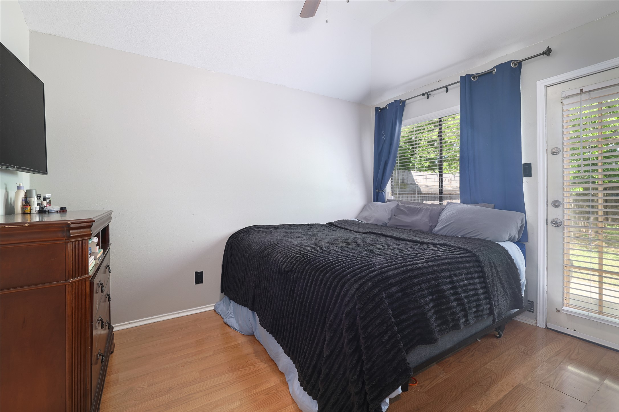 827 Topaz Lane Leander, TX 78641 - Photo 15 of 22 a bedroom with a bed and a flat tv screen on a dresser