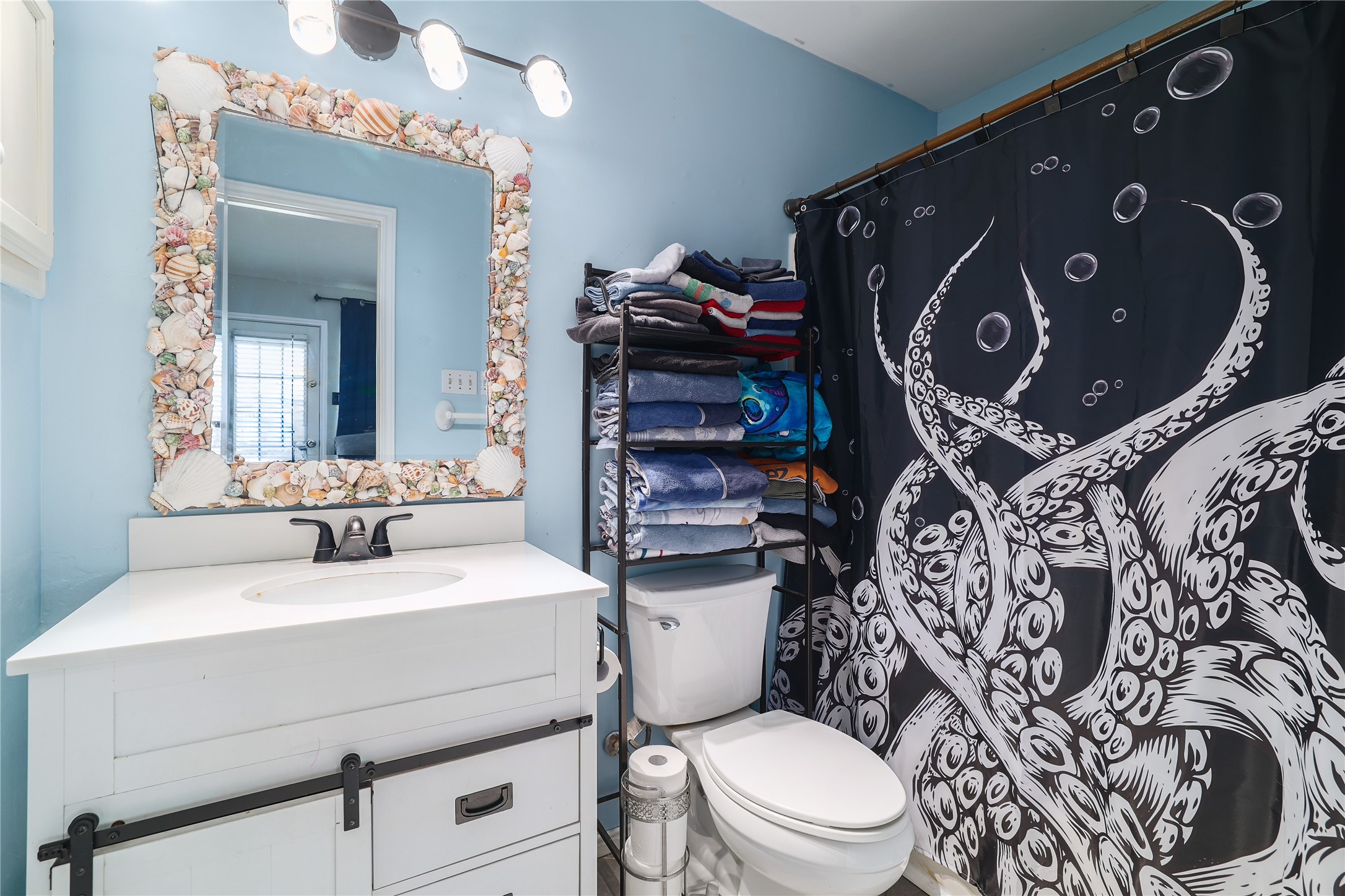 827 Topaz Lane Leander, TX 78641 - Photo 17 of 22 a bathroom with a toilet sink and mirror