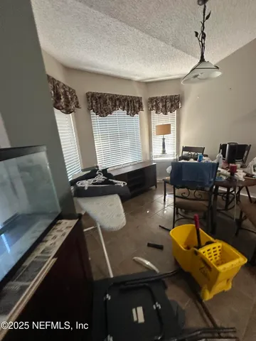 a room with furniture pool table and window