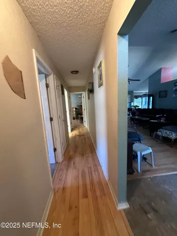 a view of hallway with wooden floor