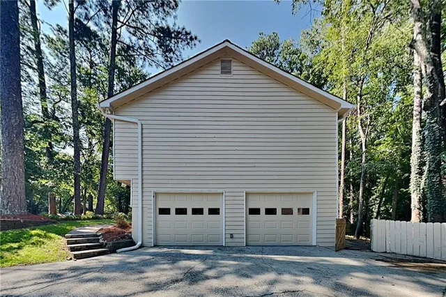 a front view of a house with a yard and tree