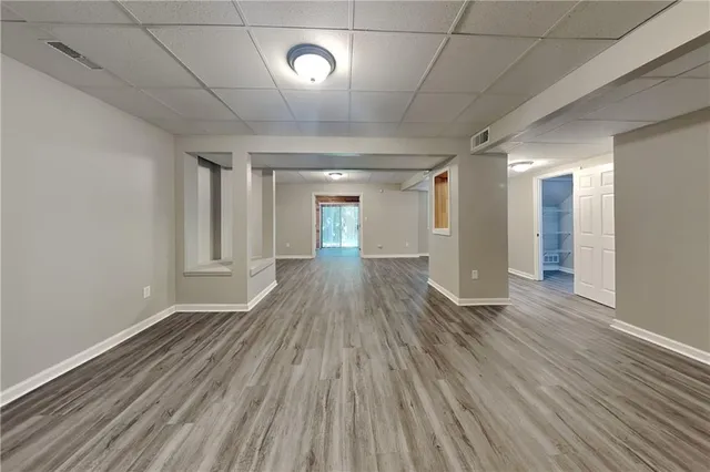 a view of empty room with wooden floor