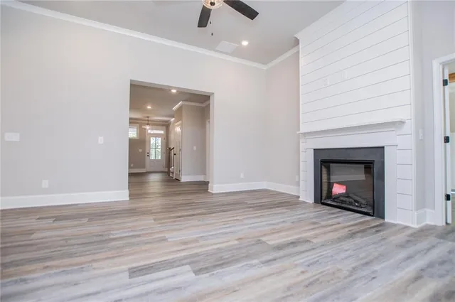 a large kitchen with granite countertop a large island in the center a sink stainless steel appliances and cabinets