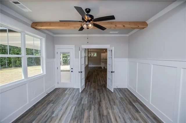 an empty room with windows and closet