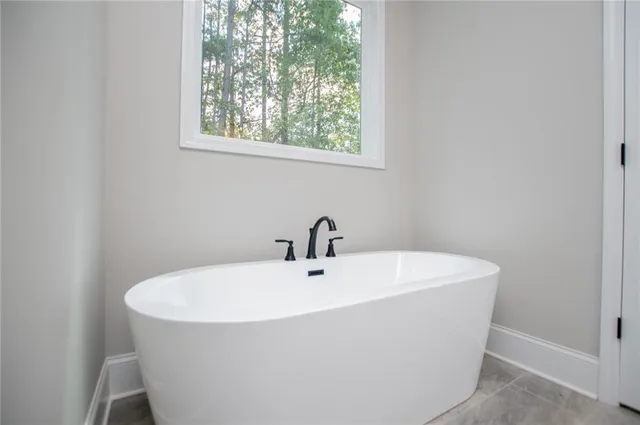 a aerial view of a house with swimming pool and large trees