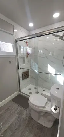 a bathroom with a toilet a sink and shower