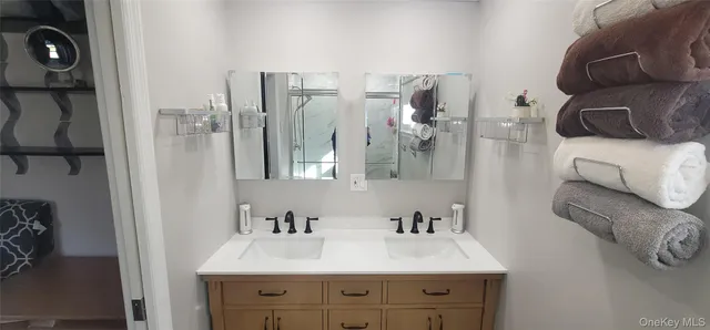 a bathroom with a sink vanity and a mirror