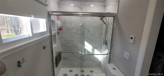 a bathroom with a glass shower door