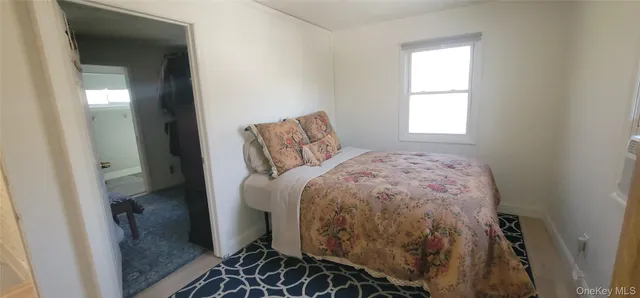 a bed sitting in a bedroom next to a window