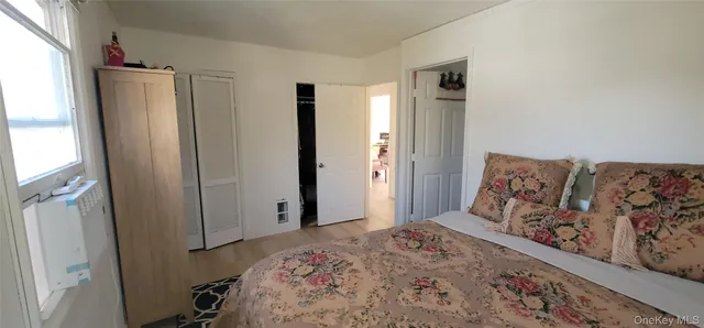 a bedroom with a large bed and a closet