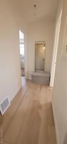 an empty room with windows and closet