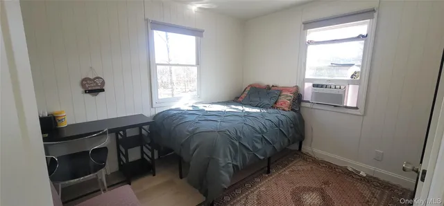 a bed sitting in a bedroom next to a window