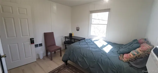 a bed sitting in a bedroom next to a window