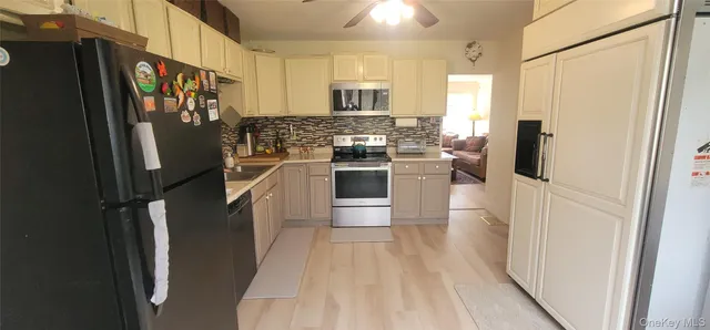 a kitchen with stainless steel appliances granite countertop a refrigerator and a stove