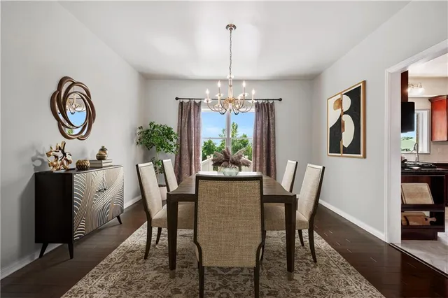 a view of a room with wooden floor chandelier and a window