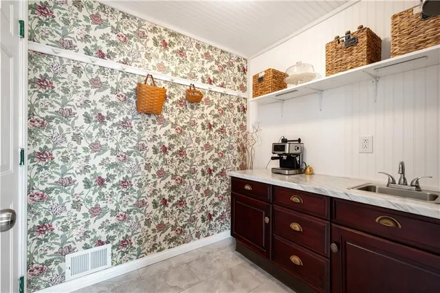 a living room with furniture two window and wooden floor