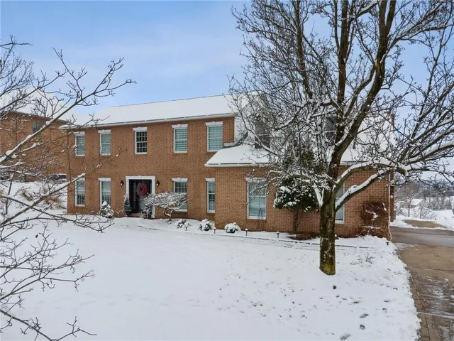 a view of a house with snow on the road