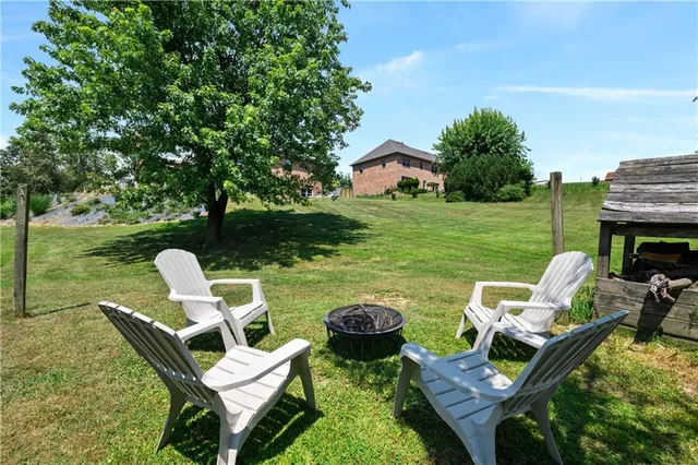 a front view of a house with a garden and trees