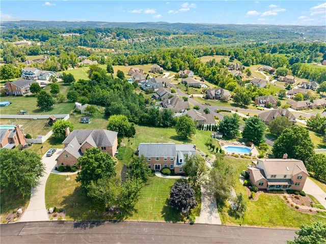 an aerial view of a house with a yard basket ball court and outdoor seating