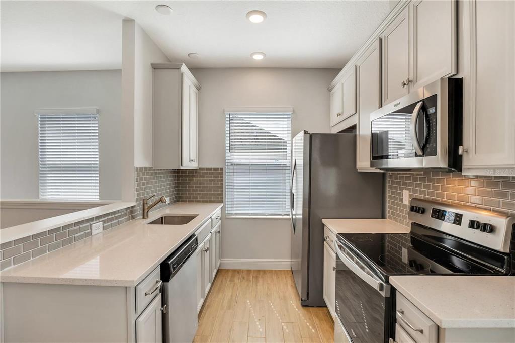 6547 Rover Way St. Cloud, FL 34771 - Photo 3 of 11 a kitchen with a sink stove top oven and refrigerator