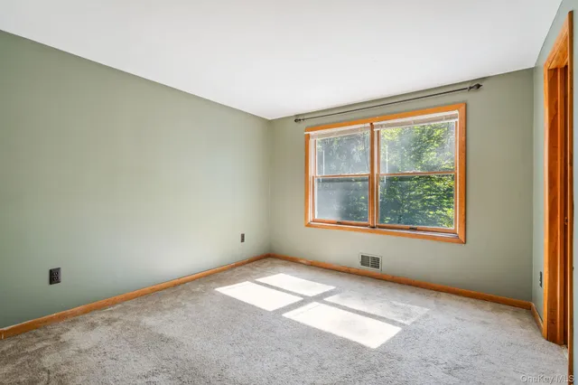 a view of a house with a big yard potted plants and large tree