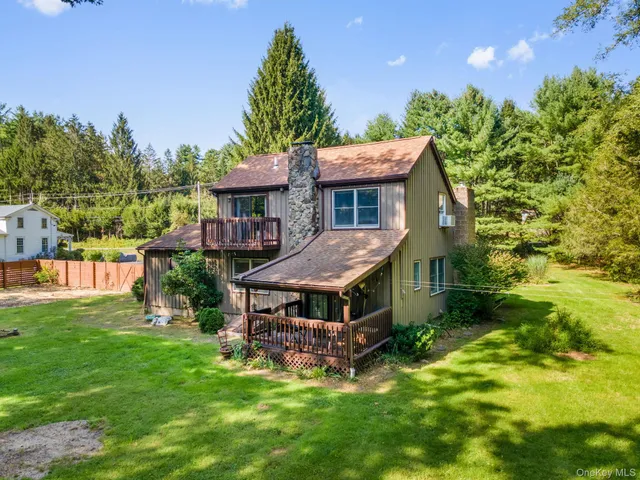 a view of backyard with a deck and wooden floor