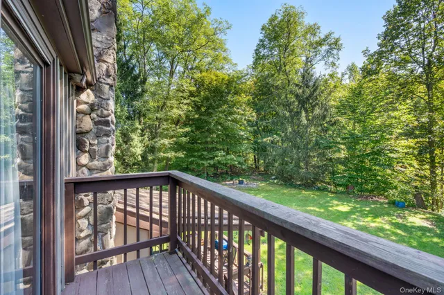 a view of a big house with a big yard and large trees