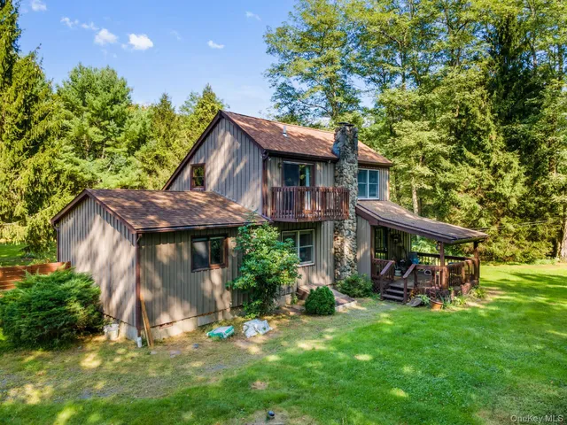 a view of a house with a tree in the background