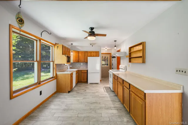 a kitchen with cabinets a sink and appliances