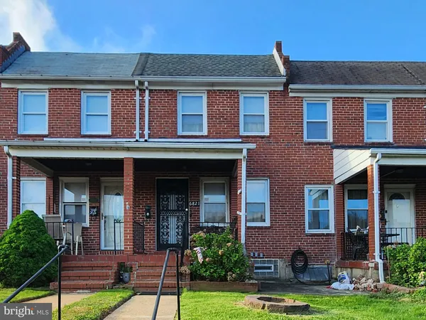 front view of brick house with a yard