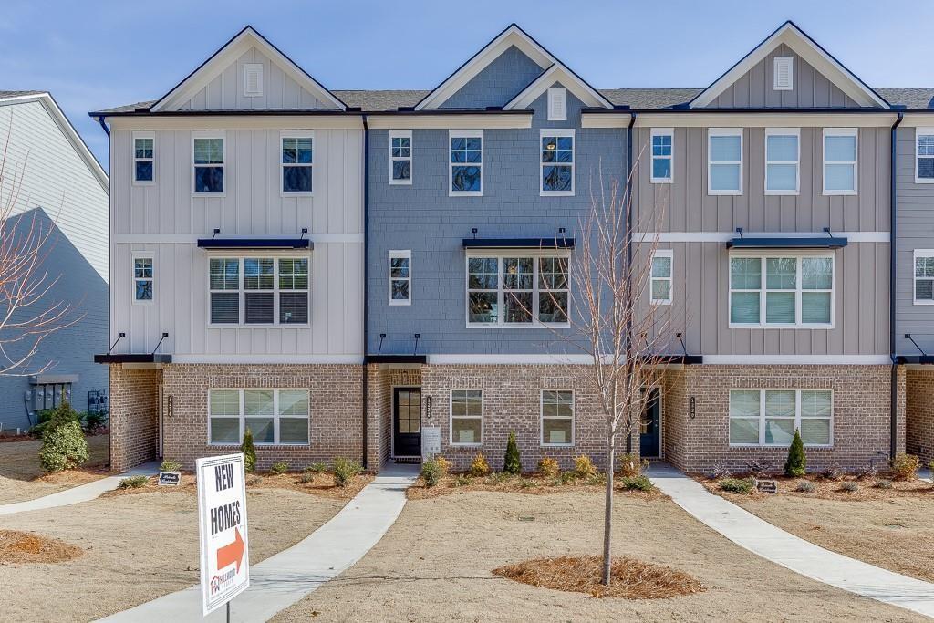 1276 Ainsworth Alley Sugar Hill, GA 30518 - Photo 1 of 56 a front view of a house with parking area