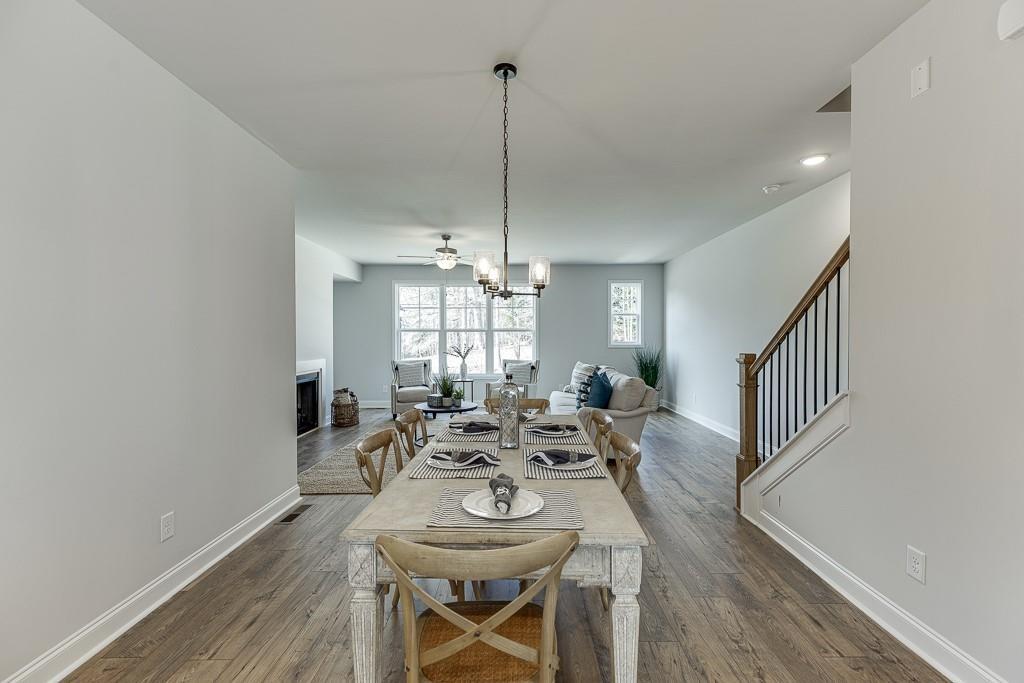 1276 Ainsworth Alley Sugar Hill, GA 30518 - Photo 13 of 56 a view of a dining room with furniture window and wooden floor