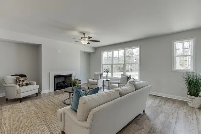 a living room with furniture and a fireplace