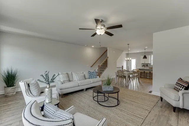 a living room with furniture and kitchen view