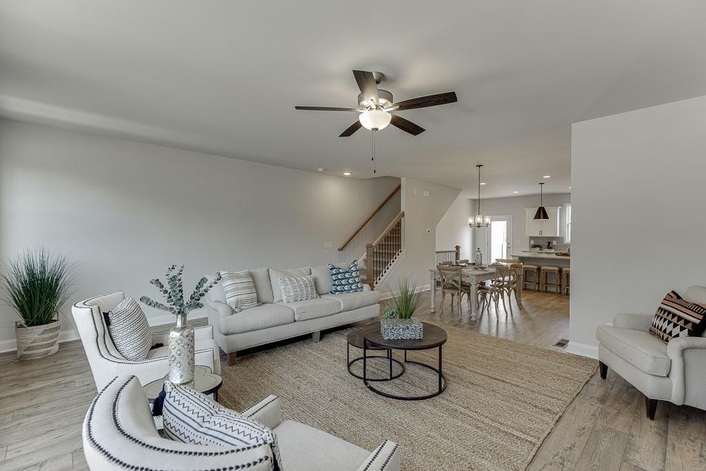 1276 Ainsworth Alley Sugar Hill, GA 30518 - Photo 16 of 56 a living room with furniture and kitchen view