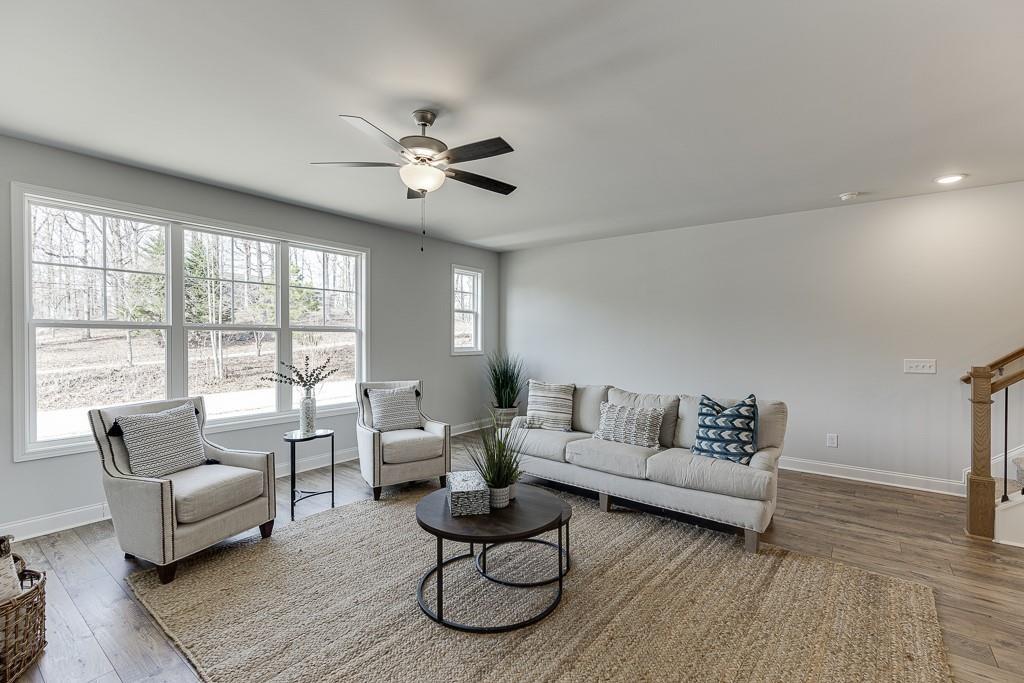 1276 Ainsworth Alley Sugar Hill, GA 30518 - Photo 17 of 56 a living room with furniture and a large window