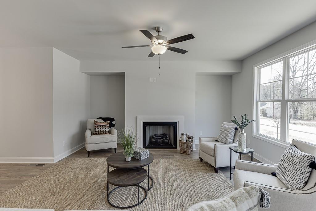 1276 Ainsworth Alley Sugar Hill, GA 30518 - Photo 18 of 56 a living room with furniture and a fireplace
