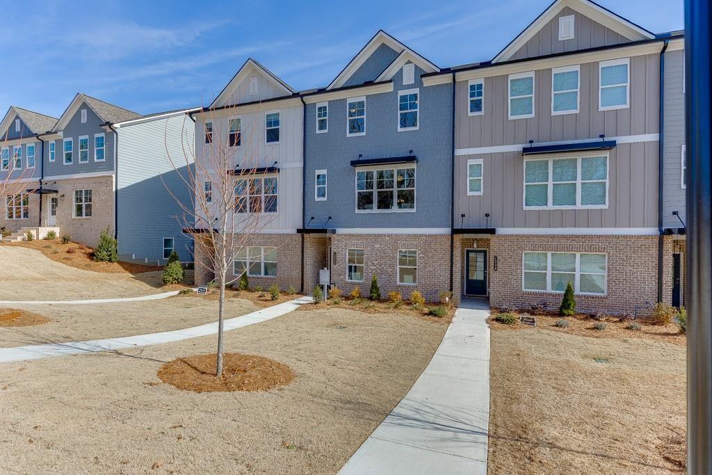 1276 Ainsworth Alley Sugar Hill, GA 30518 - Photo 2 of 56 a front view of a building with street