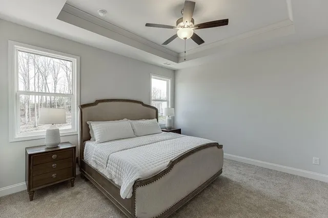 a bedroom with a large bed and a chandelier