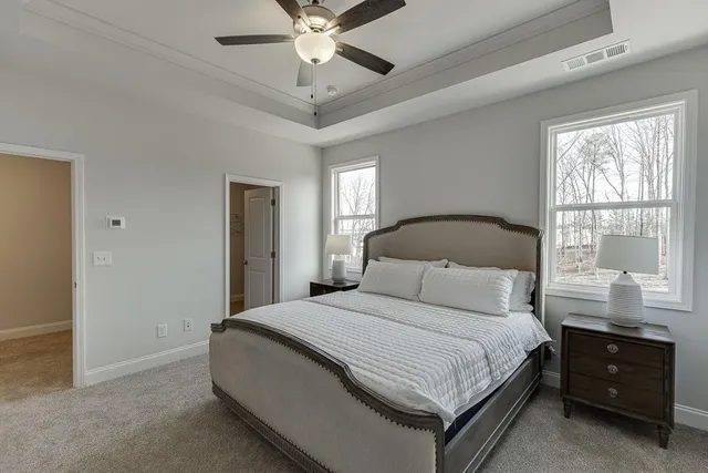 a bedroom with a large bed and a window