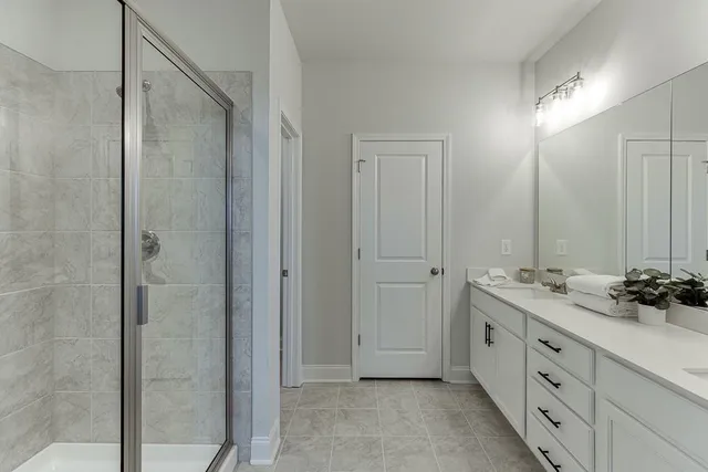 a bathroom with a double vanity sink and mirror