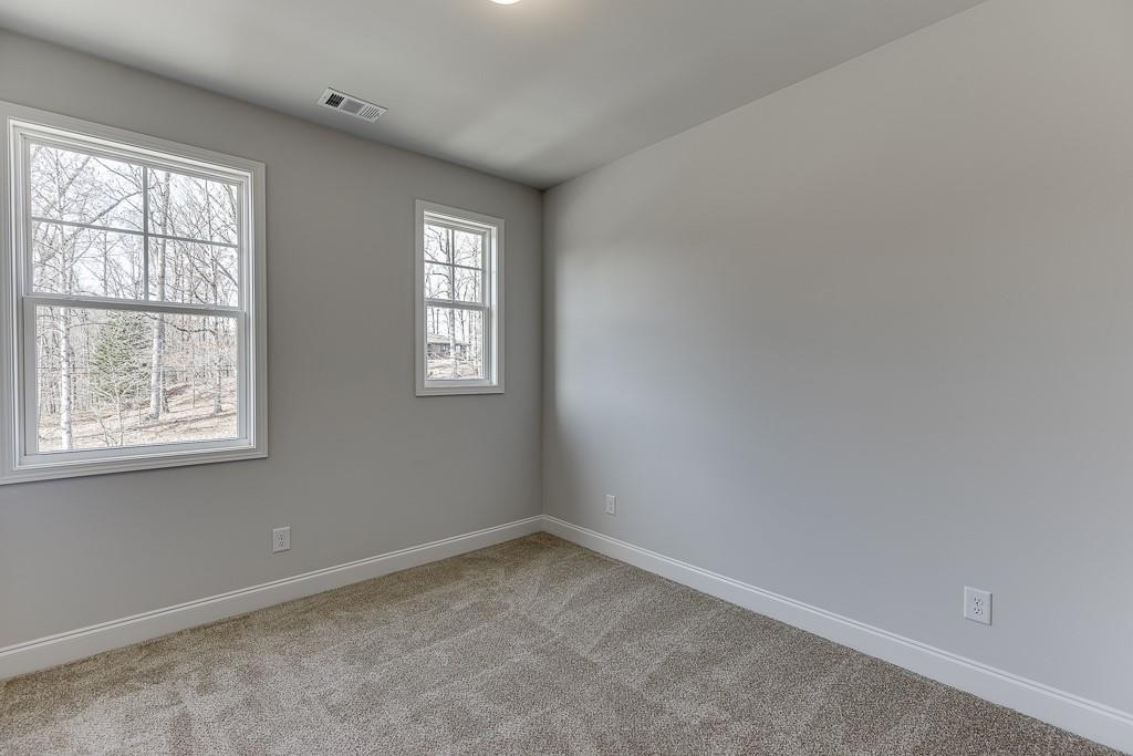 1276 Ainsworth Alley Sugar Hill, GA 30518 - Photo 27 of 56 an empty room with windows