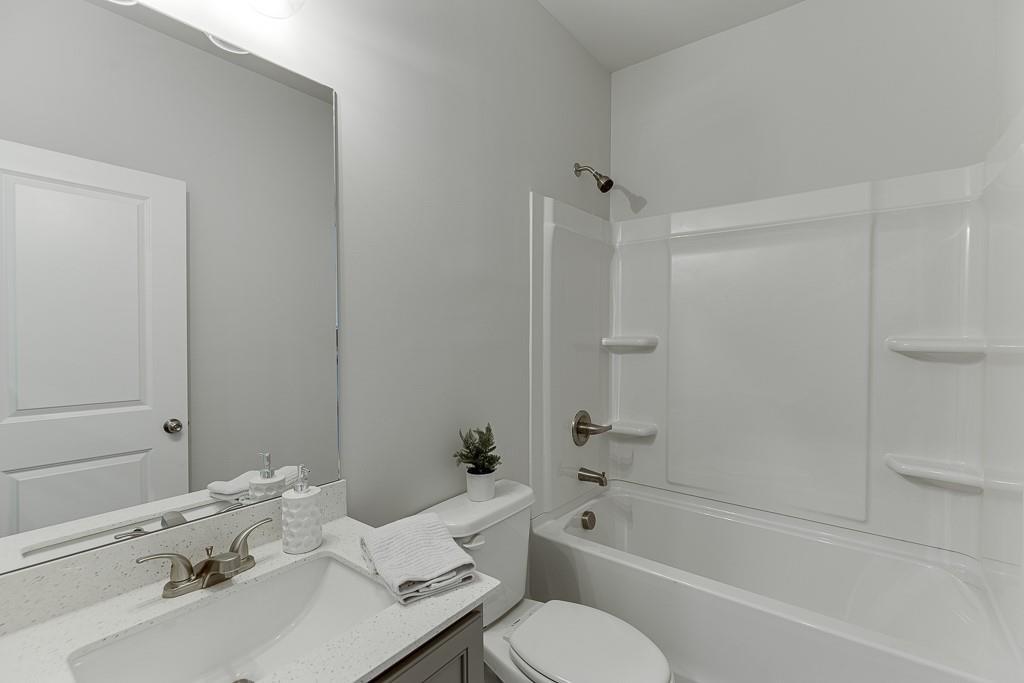 1276 Ainsworth Alley Sugar Hill, GA 30518 - Photo 31 of 56 a bathroom with a sink toilet and shower